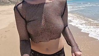On a public beach, while walking in a transparent blouse, I meet a stranger