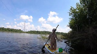 Big-Ass Blonde Rides a SUP Board Naked on a Beach