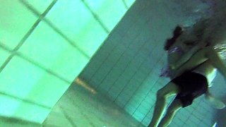 Naughty girl undresses in swimming pool and plays with dick