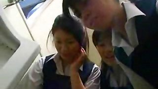 Japanese schoolgirls are teasing and playing with guy's cock
