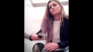 Amateur girl is playing with phone pissing on toilet