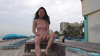 Asian amateur Lulu lifts her miniskirt to flash her pussy in outdoors