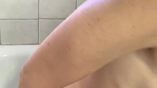 Cute tiny brunette stimulates her anal hole in shower with a dildo