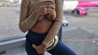 Showing off her tits in public at the airport, showing her tits to everyone