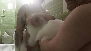 Couple take a bath and he touch her busty body