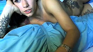 Dazzling young camgirl with lots of tattoos strokes her clit