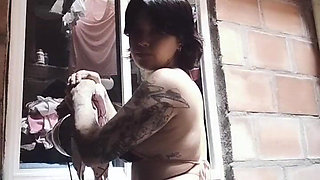 Colombian Dances While Her Neighbor Watches Her