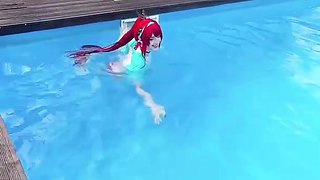 Cosplay redhead teen seductress posing in bikini in the pool
